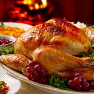 turkey dinner sitting on a table in front of a fireplace
