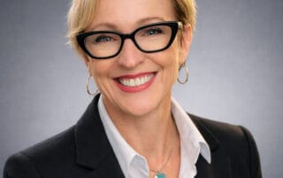 Headshot of Dr. Ac. Tammy Lalonde, CEO at Red Leaf Wellness Edmonton, wearing a black blazer, white collared shirt