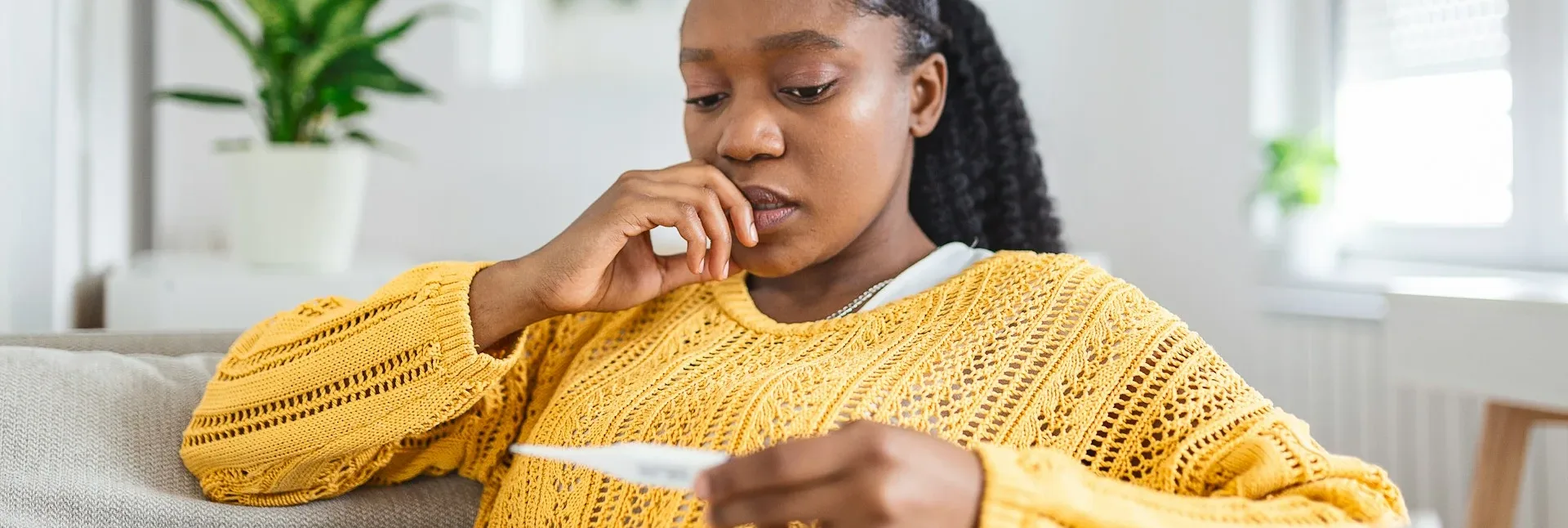 photo - a woman looking at a negative pregnancy test wondering cost of bioidentical hormone replacement therapy in canada