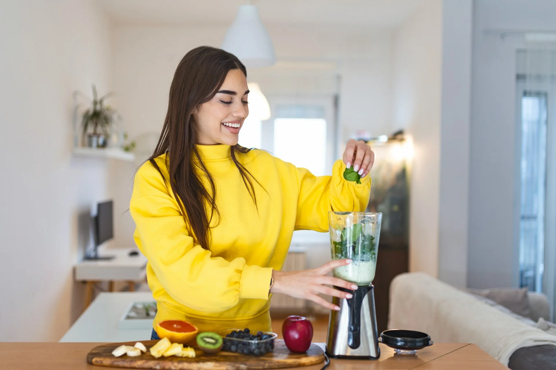 photo - a woman making a smoothie for adrenal glands and pcos