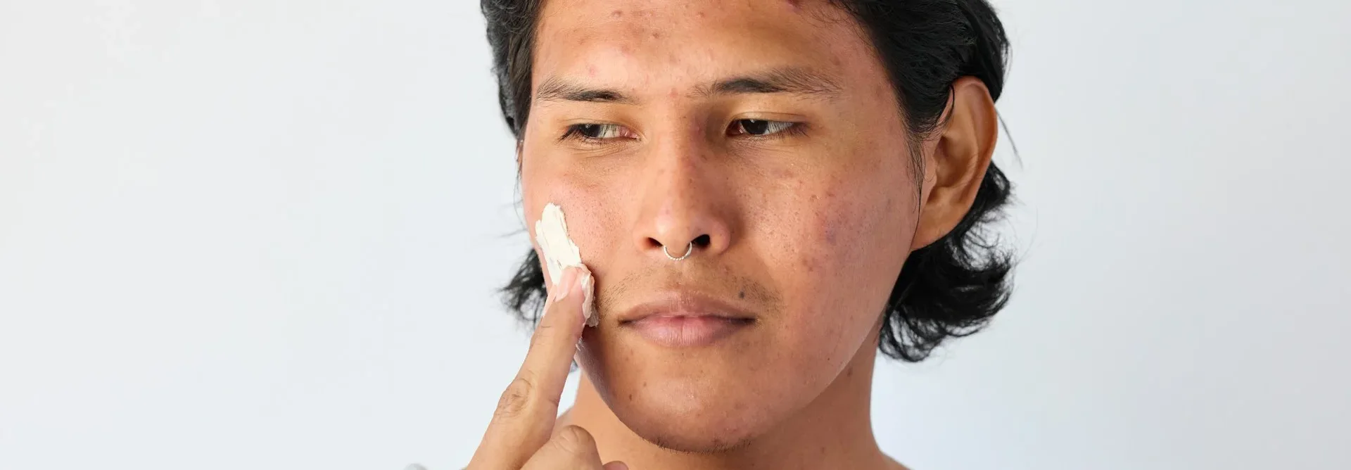 photo - a person using a cream with herbs for hormonal imbalance