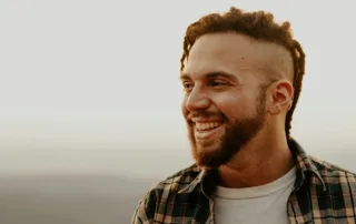 a happy man smiling out in nature thinking about before and after testosterone supplement