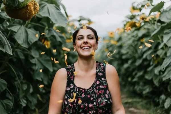 a happy woman experiencing benefits of naturopathic medicine after going through a naturopathic treatment for anxiety