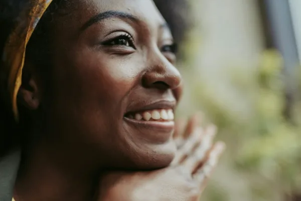 a happy woman smiling after taking probiotics for women