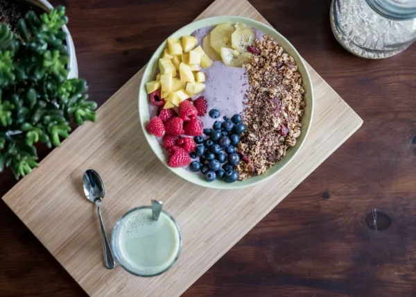 a healthy breakfast with probiotic yoghurt and fruits on a wooden tray