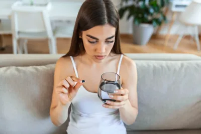 photo - a woman taking pain medication from bladder infection before period