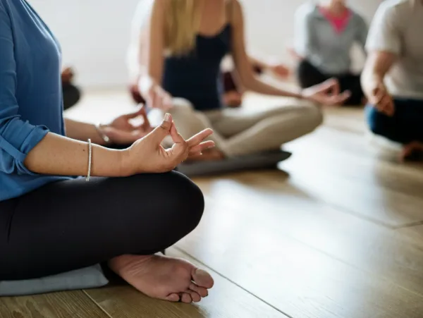 women healing from trauma through breathing exercises together