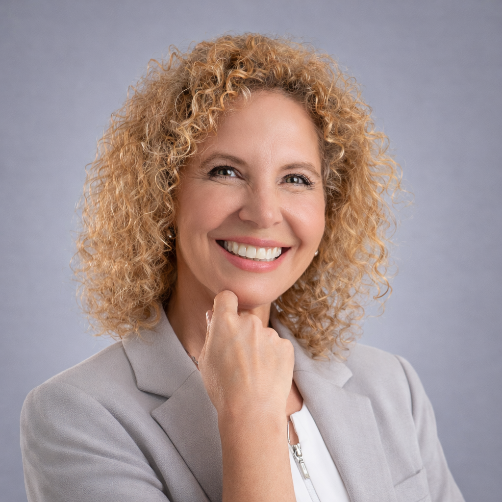 Smiling Nurse Practitioner Stacy Recalla in a white medical coat, representing compassionate hormone health care.