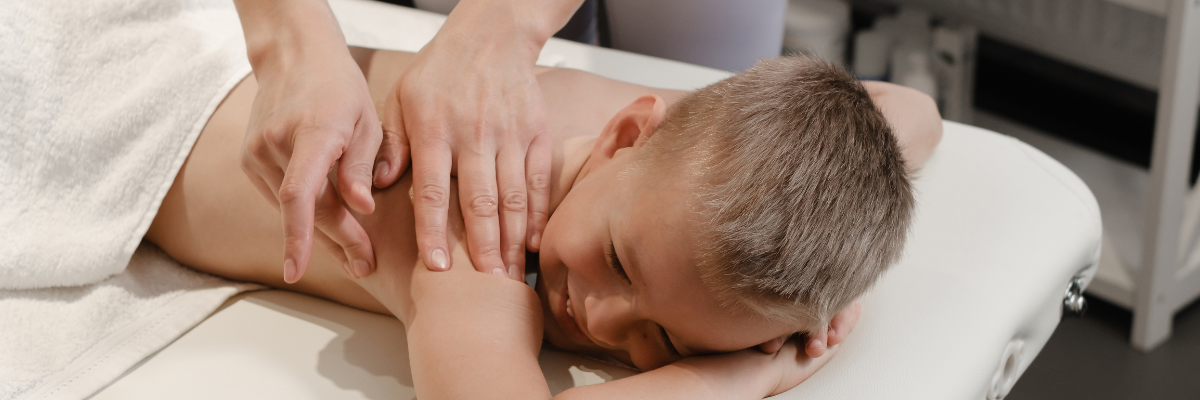 Gentle therapeutic treatment being administered to a child for pediatric acupuncture care at Red Leaf Wellness Edmonton