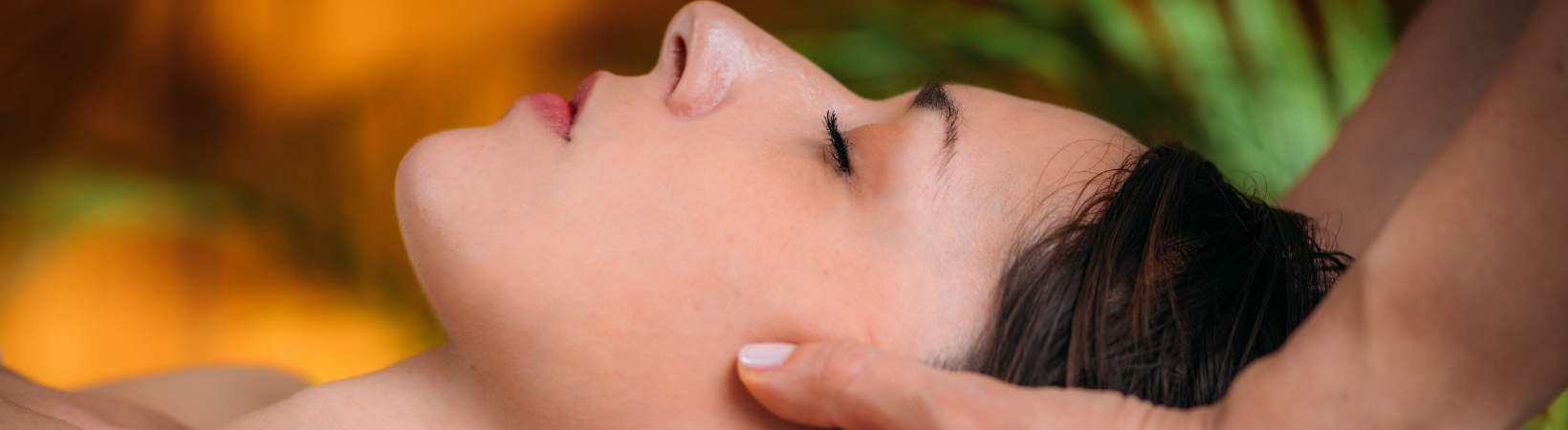 Woman receiving Biodynamic Craniosacral Therapy in Edmonton at Red Leaf Wellness, eyes closed and deeply relaxed